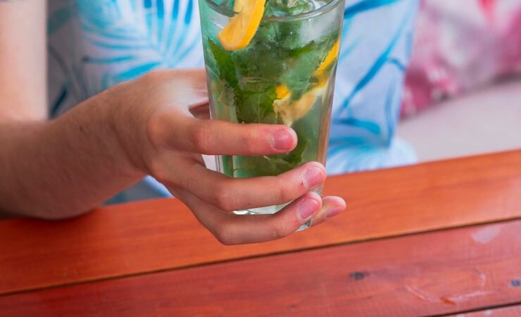 Refreshing drinks including iced lemonade, fruit smoothies, and coconut water served in clear glasses with fresh fruit garnishes